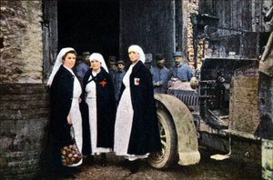 Three Women Wearing the Red Cross and the French Ambulance Staff with a Vehicle, Verdun, September 1916 by Jules Gervais Courtellemont